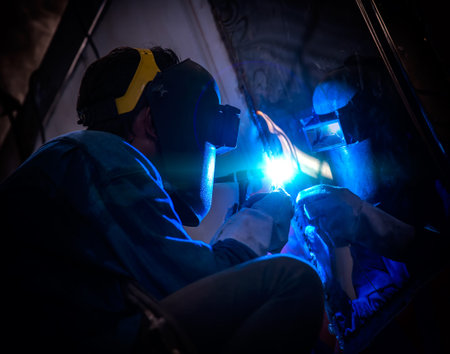 Worker welding with Argon welding