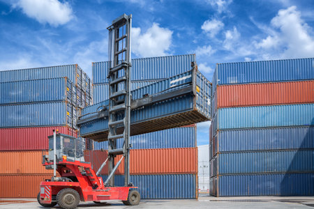 Crane lifter handling container box loading to truck in import export logistic zone
