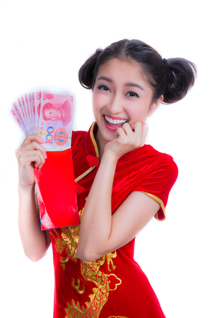 happy chinese new year. smile asian woman holding red envelope isolated on red backgroundの写真素材