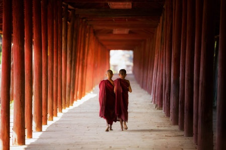 Young Buddhist monk, novic,  walking and reading in pagoda in Shin Bin Maha Laba Man Temple, Sa lay,Bagan, near Mandalay city, Myanmar.の写真素材