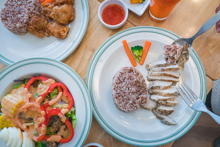 Eating for good healthy low cholesteral but high proteen, Salad, rice, chicken and orange juiceの写真素材