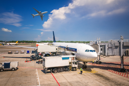 Low cost airline and small airplane loading and parking in Singapore international airportのeditorial素材