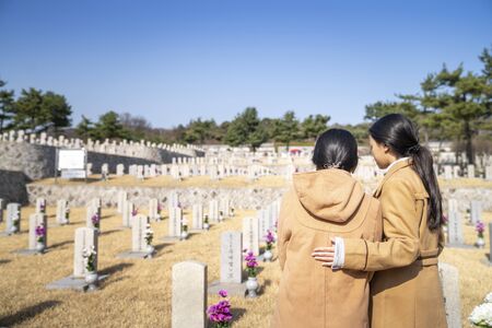 Korean people infront of tombstone in tomb of Korea war, ombstones in Seoul National Cemetery, Seoul city, South Koreaの写真素材