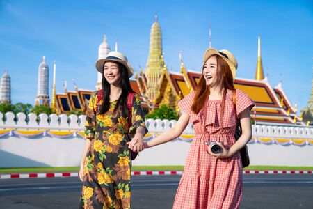 Two asian girlfriends traveling and take photo in Grand Palace and Wat phra kaew in Bangkok,Thailandの写真素材