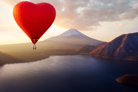 Hot air fly over Fuji mountain in morning sunrise time , Tokyo, japan, this image can use for love, valentine day, landscape, adventure and travel conceptの写真素材