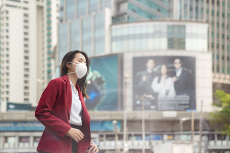 Asian girl use a protection mask for prevent PM 2.5 and corona virus or civic 19 in Bangkok city.のeditorial素材