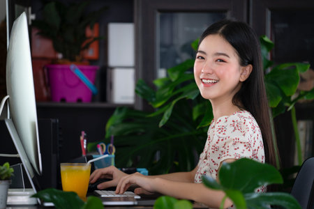 Asian girl working at home by computer and internet. this image can use for Work at home of WAH concept.の写真素材