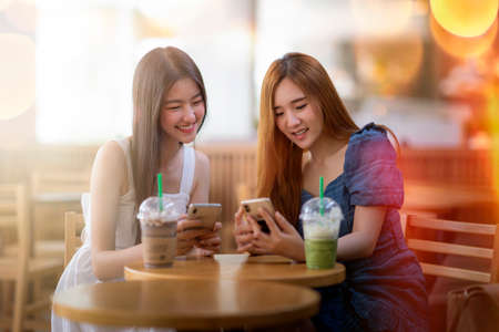 two asian girl enjoy shopping togather in department store, this picture can use for sale, fashion and lifestyle conceptの写真素材