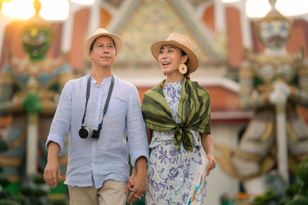 Wat Arun Ratchawararam temple. Couple traveller walking in the temple, landmark thailand tourist...