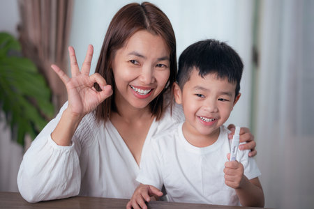 Mother test covid19 for her son with saliva ATK at they home, Asian family use an antigen test kit...