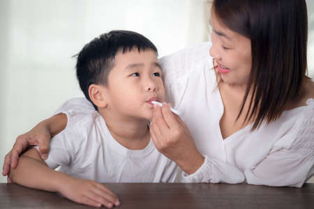 Mother  uses an antigen test kit on her sonの写真素材