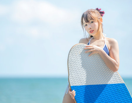 Japanese girl in bikiny stay on the beach and swimming pool at report in Phuket, Thailand