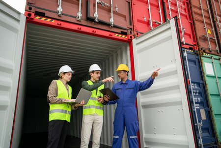 Customer service staff explain about container spec to his customer at inside of container cabinet in Shipping companyの写真素材