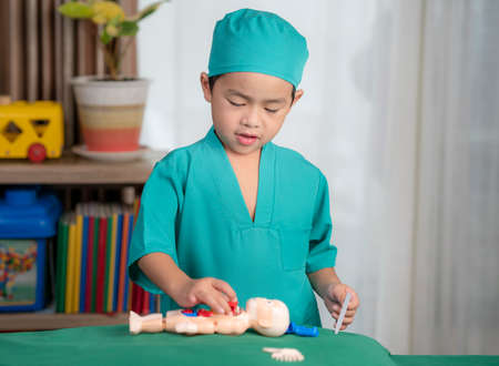 Asian boy play surgery with toy, he have dream for do a doctor job in futureの写真素材