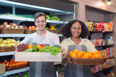 American man grocery working in supermarket with fruit and vegetable background, owner business man for shopping storeの写真素材