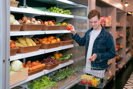 An European man buy a fruit and vegetable from refrigerator cold in food onvenience store for drink at homeの写真素材