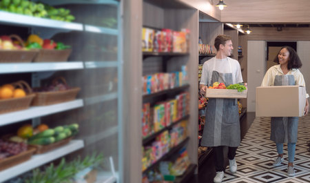 American man grocery working in supermarket with fruit and vegetable background, owner business man for shopping storeの写真素材