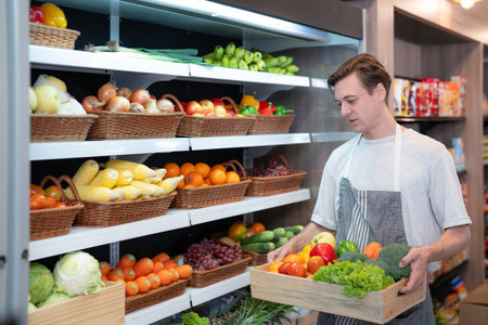 American man grocery working in supermarket with fruit and vegetable background, owner business man for shopping storeの写真素材