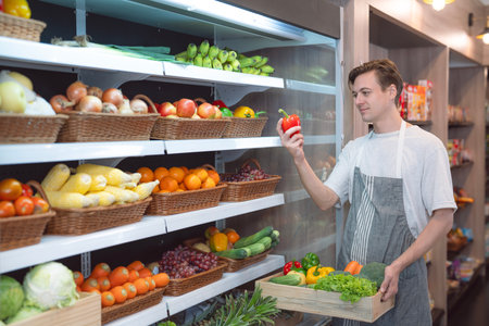 American man grocery working in supermarket with fruit and vegetable background, owner business man for shopping storeの写真素材