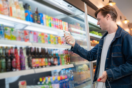 An European man but a bottle of mineral water from refrigerator cold in onvenience store for drink at homeの写真素材