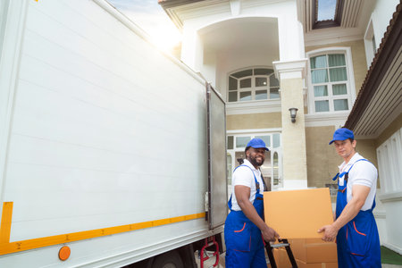 Workers unloading boxes from van outdoors. Moving service and customer need for move to new houseの写真素材