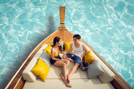 Asian couple lover travel and relax in they honeymoon trip on the wooded boat at Koh phi phi island, Maya beach, Phang nga near Phuket in Thailandの写真素材