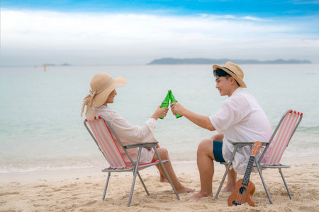 Asian traveller couple playing and sweet togather on the beach between honeymoon day at Phi phi island maya beach near Phuket, Thailandの写真素材