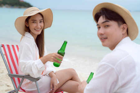 Asian traveller couple playing and sweet togather on the beach between honeymoon day at Phi phi island maya beach near Phuket, Thailandの写真素材