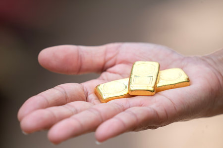 Gold bar and Gold Jewellery on hand for savingの写真素材