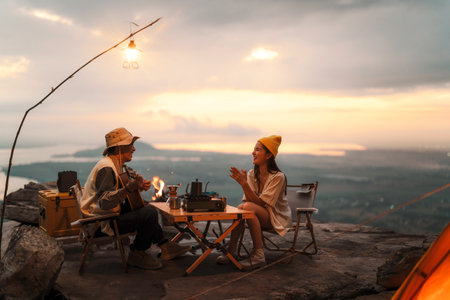 Asian couple sweet in tent inside on they camping trip, traveller relax and sleep togather in out door and camping tripの写真素材