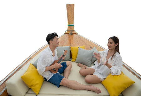 Asian traveller couple sit togather on the traditional wooded long tail boat head between sea travel trip to Phi phi island on they honey moon trip, Die cut isolated white background for make an art workの写真素材
