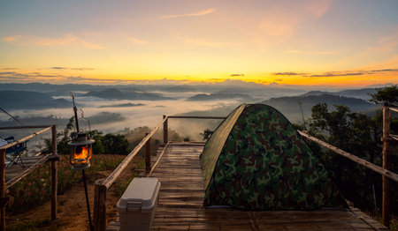 tent and camping at Tak with fog mountain and sun rise backgroung, Mon Saeng Tawan, Tak, Thailandの写真素材