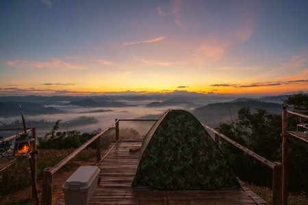 tent and camping at Tak with fog mountain and sun rise backgroung, Mon Saeng Tawan, Tak, Thailandの写真素材