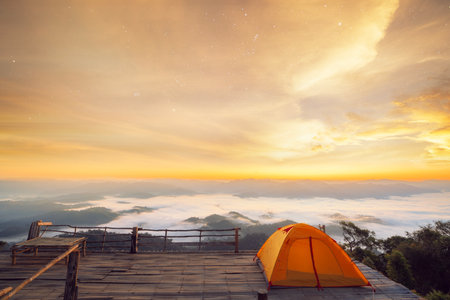 Orange tent in camping area in top at Tak, North of Thailand in winter season and balloon, Laandscape view point in travel point near Chiang mai, Thailandの写真素材