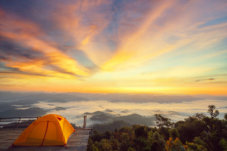 Orange tent in camping area in top at Tak, North of Thailand in winter season and balloon, Laandscape view point in travel point near Chiang mai, Thailandの写真素材