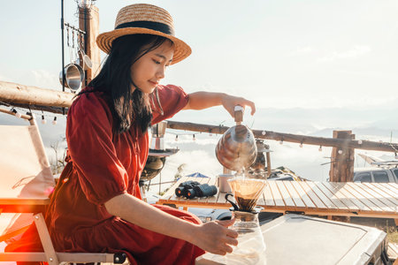 Asian woman traveller relax in camping at Tak, north of Thailand, Tent travel in Chiang mai with fog and mountain in morning time backgroundの写真素材