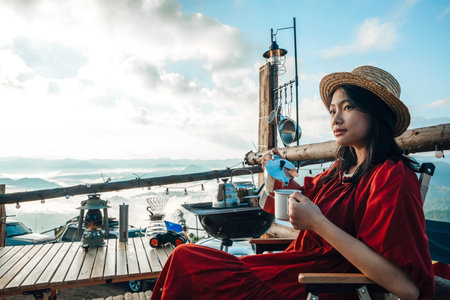 Asian woman traveller relax in camping at Tak, north of Thailand, Tent travel in Chiang mai with fog and mountain in morning time backgroundの写真素材
