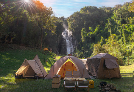 Tent and camping with Mae Tia waterfall and mountain background at inthanon national park in Chiang mai, Thailand, un seen travel point for camping and relax in holidayの写真素材