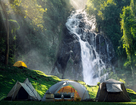 Tent and camping with Mae Tia waterfall and mountain background at inthanon national park in Chiang mai, Thailand, un seen travel point for camping and relax in holidayの写真素材