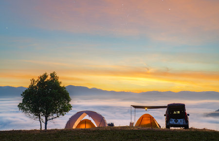 Orange tent in camping area in top of Mea Omgi at Tak, North of Thailand in winter season and balloon, Laandscape view point in travel point near Chiang mai, Thailandの写真素材
