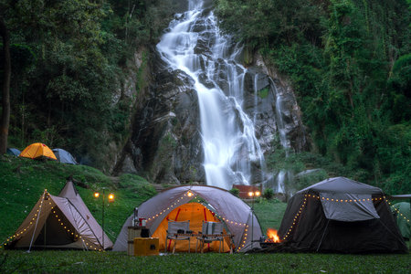 Light and campfire on night time at Mae tear waterfall near Doi inthanon in Chiang mai, Northen, Thailandの写真素材