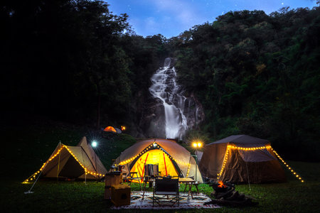 Light and campfire on night time at Mae tear waterfall near Doi inthanon in Chiang mai, Northen, Thailandの写真素材