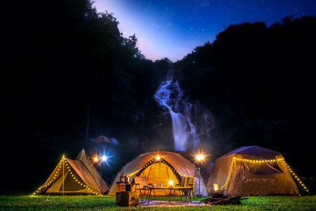 Light and campfire on night time at Mae tear waterfall near Doi inthanon in Chiang mai, Northen, Thailandの写真素材