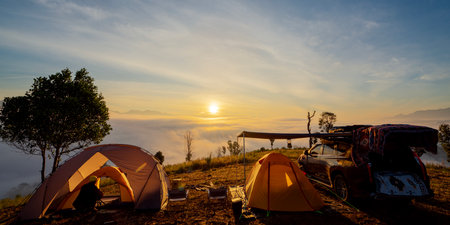 Orange tent in camping area in top of Mea Omgi at Tak, North of Thailand in winter season and balloon, Laandscape view point in travel point near Chiang mai, Thailandの写真素材