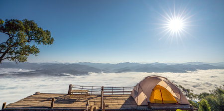 Orange tent in camping area in top at Tak, North of Thailand in winter season and white tone, Laandscape view point in travel point near Chiang mai, Thailandの写真素材