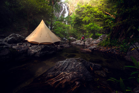Tent and camping with Klonglan water fall in Khlong Lan National Park in Kamphaeng Phet near Chiang mai, Thailand, un seen travel point for camping and relax in holidayの写真素材
