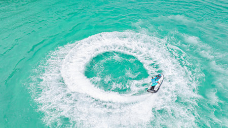 Boat drive on the sea make a cycle wave on Pattaya beach in Thailandの写真素材