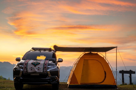 Pop up tarp building with suv car and tent on the moutain with sunset sky at chiang mai, Thailandの写真素材