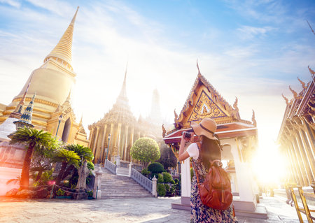 Asian woman traveller take a photo and travel in Bangkok grand palace and wat phra kaew in Bangkok city, Thailandの写真素材