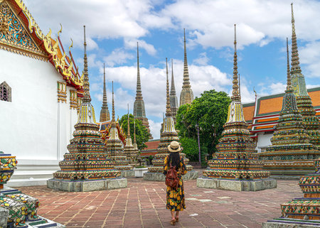Asian travellert woman walking in Pagoda area in Wat Pho near Thailand grand palace and wat phra kaew in Bangkok city, Thailandの写真素材